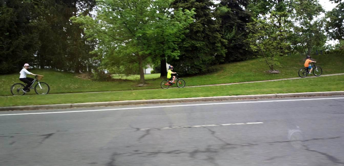 biking on the sidewalk w adult